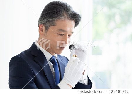 On-site purchase: A man assessing precious metals 129401762