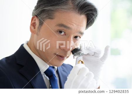 On-site purchase: A man assessing precious metals 129402835