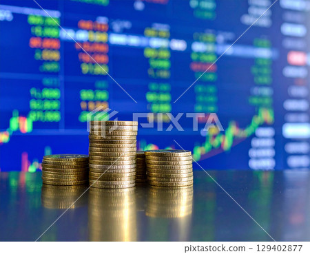 AI generated stack of shiny dollar coins on reflective glass table with modern trading floor backdrop featuring stock market boards and financial data displays 129402877