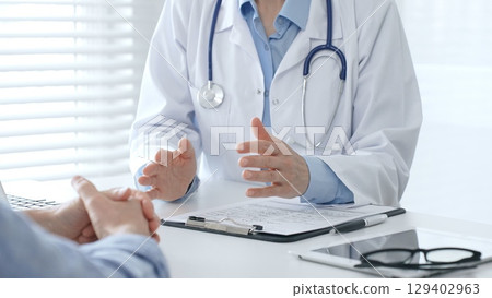 Female doctor explaining diagnosis to her patient during a medical consultation in a bright medical office, healthcare and medical concept. Medicine and health care concept Female doctor explaining diagnosis to her patient during a medical consultation in a bright medical office, healthcare and medical concept. Medicine and health care concept 129402963
