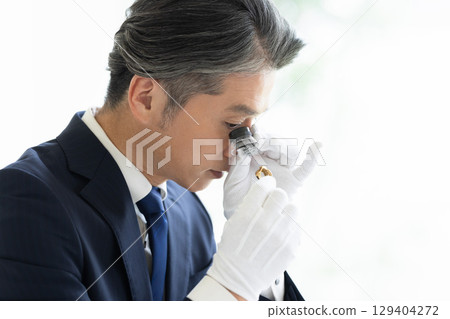 On-site purchase: A man assessing precious metals 129404272