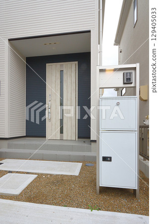 Delivery box installed at the entrance of a house Delivery box installed at the entrance of a house 129405033