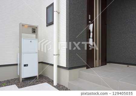 Delivery box installed at the entrance of a house Delivery box installed at the entrance of a house 129405035