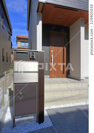 Delivery box installed at the entrance of a house Delivery box installed at the entrance of a house 129405038