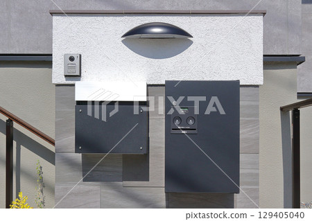 Delivery box installed at the entrance of a house Delivery box installed at the entrance of a house 129405040