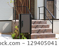Delivery box installed at the entrance of a house 129405041