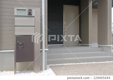 Delivery box installed at the entrance of a house Delivery box installed at the entrance of a house 129405044