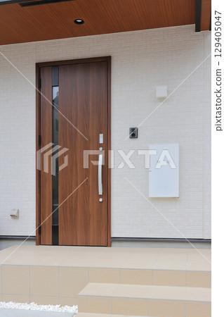 Delivery box installed at the entrance of a house Delivery box installed at the entrance of a house 129405047