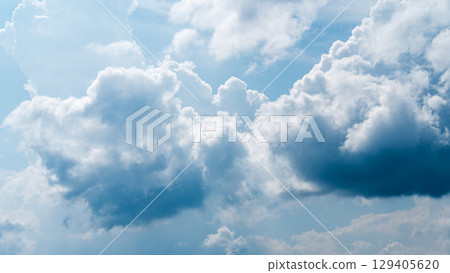 Cumulonimbus clouds appear in the midsummer blue sky 129405620