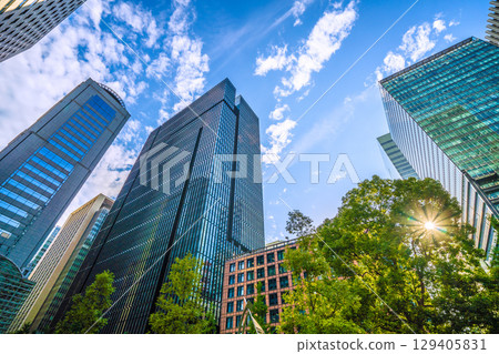 A sudden thunderstorm passes through the Tokyo cityscape in Japan... Otemachi business district. View of buildings such as Otemachi Tower = August 8th 129405831