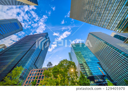 A sudden thunderstorm passes through the Tokyo cityscape in Japan... Otemachi business district. View of buildings such as Otemachi Place = August 8th 129405970