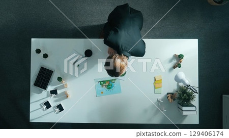 Top down view of business woman looking at clean energy document. Alimentation. 129406174