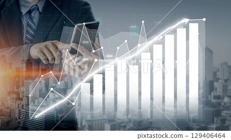 Business professional analyzing smartphone data with digital graphs and charts in the background, showcasing financial growth and market trends in a modern cityscape. Copula 129406464