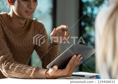 Modern UX UI Designer Working on Tablet in Bright Office Environment for Innovative Digital Solutions 129406632