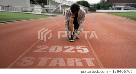 Runner Preparing for a Race on Track with 2025 Start Line Symbolizing New Beginnings and Future Goals in Sports and Personal Achievements Runner Preparing for a Race on Track with 2025 Start Line Symbolizing New Beginnings and Future Goals in Sports and Personal Achievements 129406705