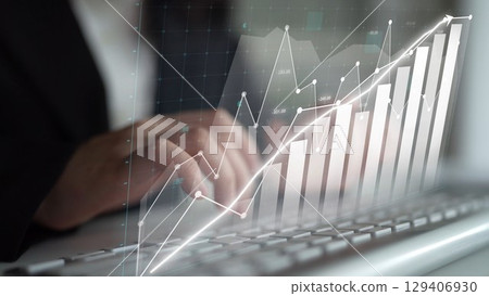 Person Typing on Keyboard with Graph Overlay Showing Growth in Financial Data, Business Performance, and Investment Trends in Modern Office Environment Copula 129406930