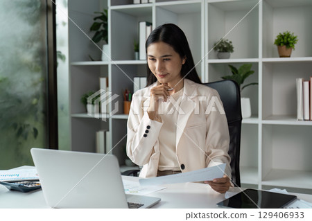 Analyzing reports office environment businesswoman modern workspace focused viewpoint professional insights for growth Analyzing reports office environment businesswoman modern workspace focused viewpoint professional insights for growth 129406933
