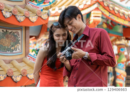 Celebrating chinese new year a young couple captures joyful moments at a colorful festival outdoor setting candid Celebrating chinese new year a young couple captures joyful moments at a colorful festival outdoor setting candid 129406983