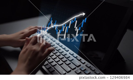 Focused hands typing on a sleek laptop keyboard with a luminous financial graph overlay depicting growth and success in a dark workspace setting Copula Focused hands typing on a sleek laptop keyboard with a luminous financial graph overlay depicting growth and success in a dark workspace setting Copula 129406984
