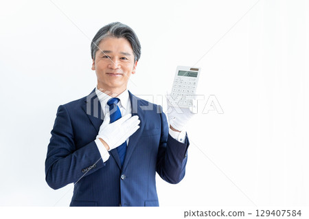 Buyer appraiser, man wearing white gloves and holding a calculator 129407584