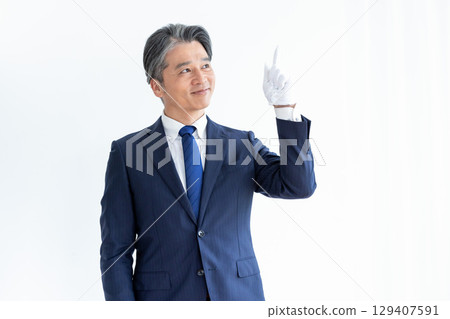 Buyer appraiser, man wearing white gloves and holding a calculator 129407591