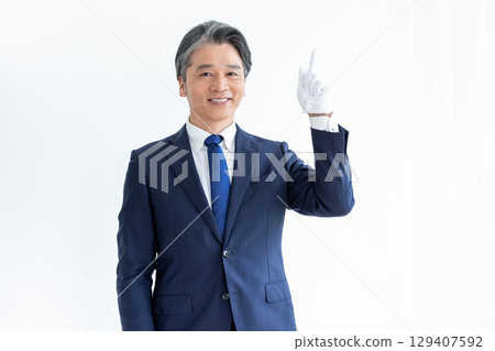 Buyer appraiser, man wearing white gloves and holding a calculator 129407592