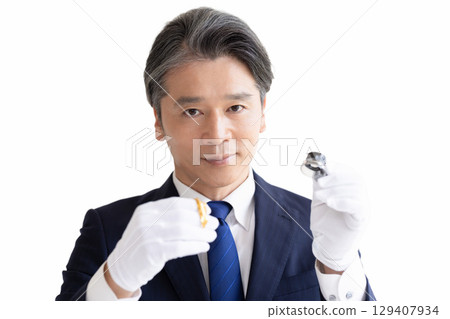 On-site purchase: A man assessing precious metals 129407934
