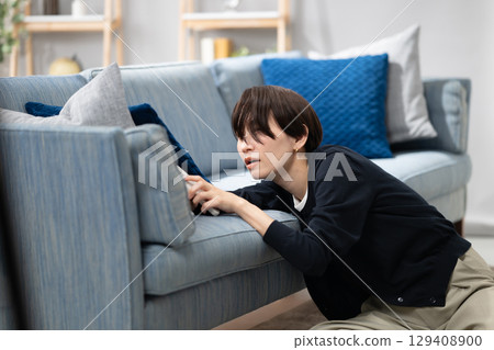 A tired woman falling asleep 129408900