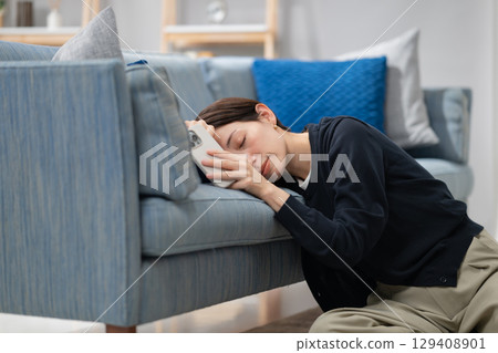 A tired woman falling asleep 129408901