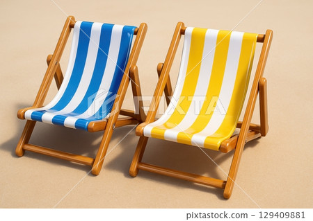 Two classic striped beach chairs, blue and yellow, ready for summer vacation and relaxation 129409881