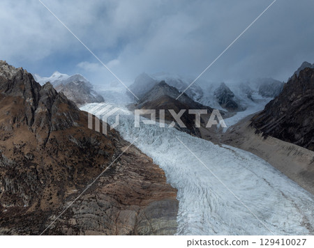 Aerial view of beautiful hanging glacier in high altitude mountains landscape 129410027
