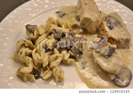 Chicken fricassee (French cuisine) and fusilli (Italian cuisine) at a restaurant in Doha, Qatar 129410145