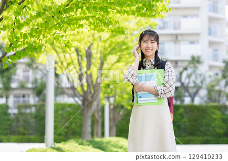 Female college student walking on campus Female college student walking on campus 129410233