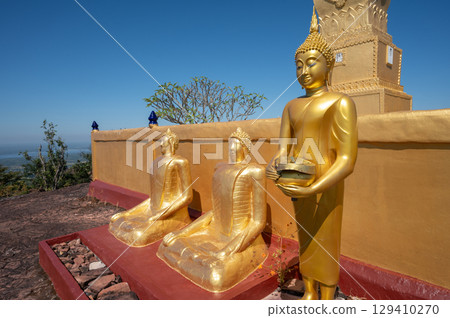 Buddha statues situated in the area of Luang Pu Wang pagoda on Phu Langka mountain in Bueng Kan province of Thailand. This site is a prime viewpoint to watch the sunrise and landscape as far as Laos. 129410270
