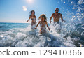 Smiling family playing in the sea 129410366