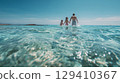 Smiling family playing in the sea 129410367