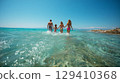 Smiling family playing in the sea 129410368