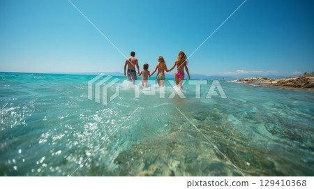 Smiling family playing in the sea 129410368