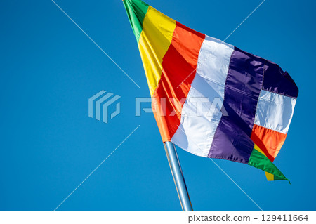 The temple's five-colored flag fluttering in the blue sky 129411664