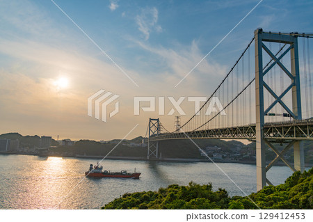 [Fukuoka Prefecture] Evening view of the Kanmon Strait, Kanmon Bridge, and passing ships from Mekari PA 129412453
