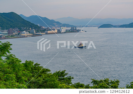 [Fukuoka Prefecture] Evening view of the Kanmon Strait and ships passing by from Mekari PA 129412612