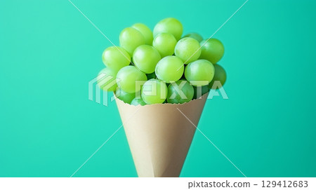 Green grape fruit closeup organic natural snack healthy food on cone wrapped Green grape fruit closeup organic natural snack healthy food on cone wrapped 129412683