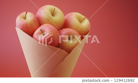 Red apple closeup organic natural snack healthy food on cone wrapped 129412692