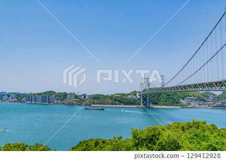 [Fukuoka Prefecture] Kanmon Strait, Kanmon Bridge, and ships passing by on a clear day as seen from Mekari PA 129412928