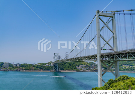 [Fukuoka Prefecture] Kanmon Strait, Kanmon Bridge, and ships passing by on a clear day as seen from Mekari PA 129412933