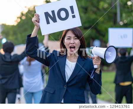 A woman shouting and holding a placard that reads "No!" 129413761