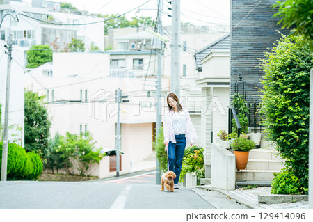 Young woman walking with pet 129414096
