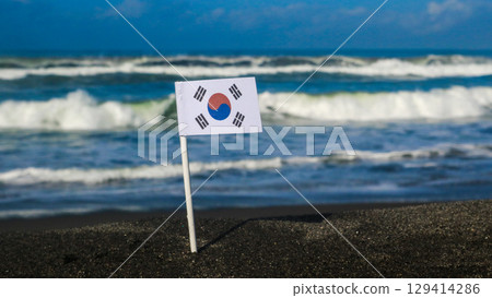 South Korea's national flag on a sandy beach with the sea in the background. Travel destination asia concept South Korea's national flag on a sandy beach with the sea in the background. Travel destination asia concept 129414286