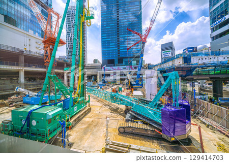 Tokyo cityscape, Japan, August 8th. Huge heavy machinery such as crawler cranes and pile drivers are lined up... A new chapter begins = Shibuya 129414703