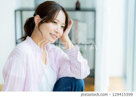 A woman relaxing in the room 129415399